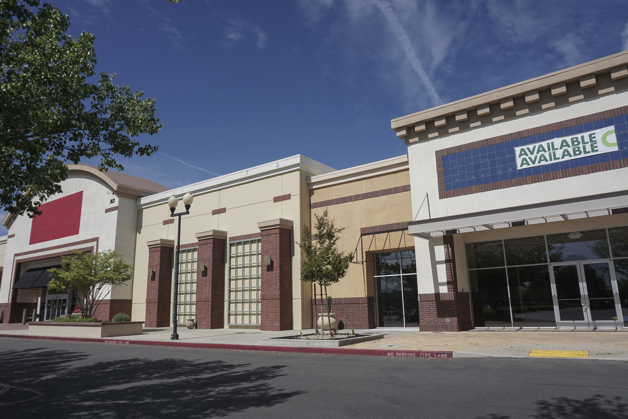 Two retail storefronts available for lease in a strip mall